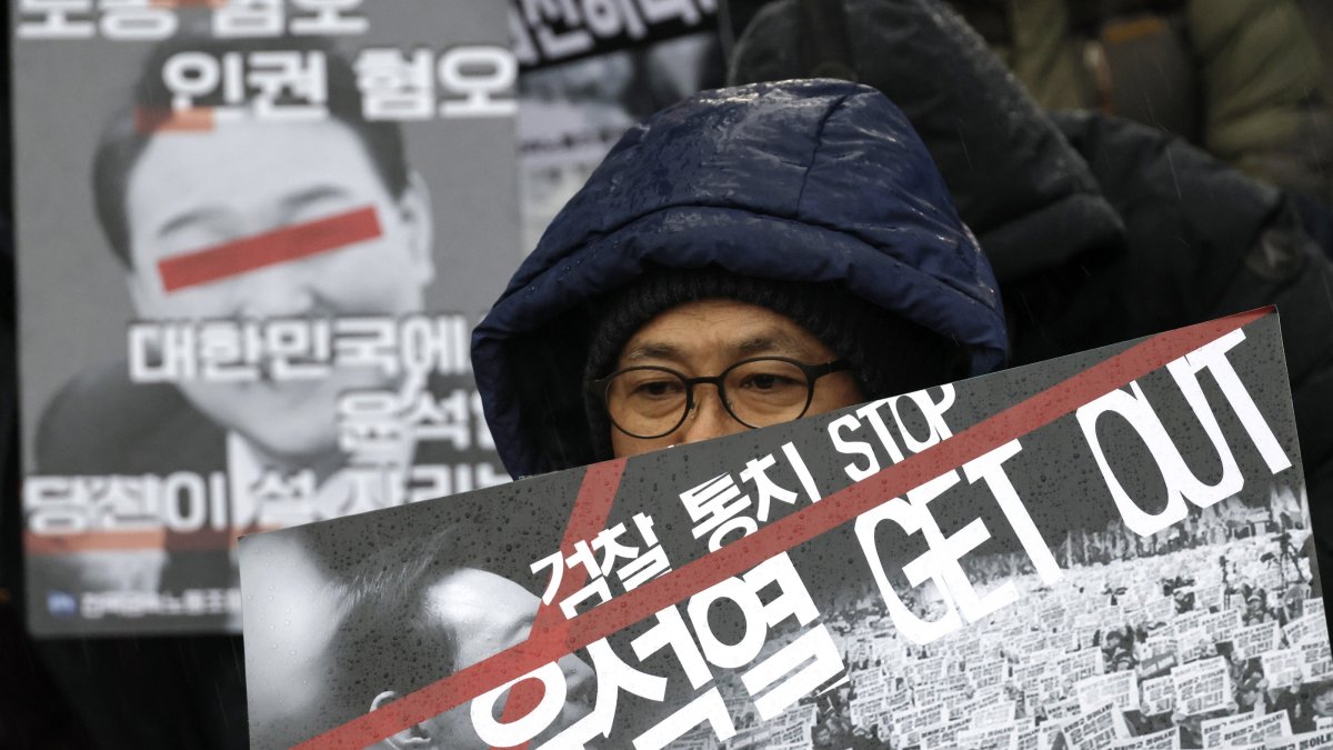 Protesters hold placards reading 'Yoon, get out' during a demonstration calling for the dismissal and impeachment of South Korean president in Seoul, South Korea, Dec. 5, 2024. (EPA Photo)