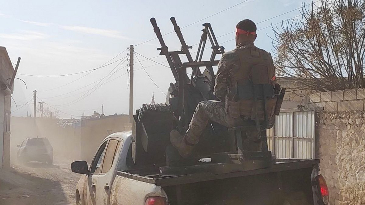 Syrian National Army (SNA) members advance in villages near central Manbij, Syria, Dec. 8, 2024. (AA Photo)
