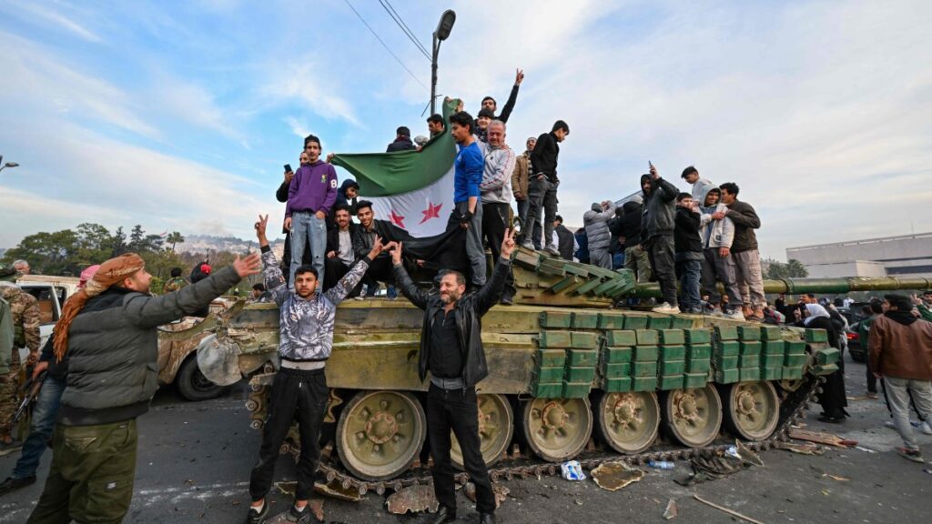 People celebrate with anti-regime fighters at Umayyad Square in Damascus, Syria, Dec. 8, 2024. (AFP Photo)