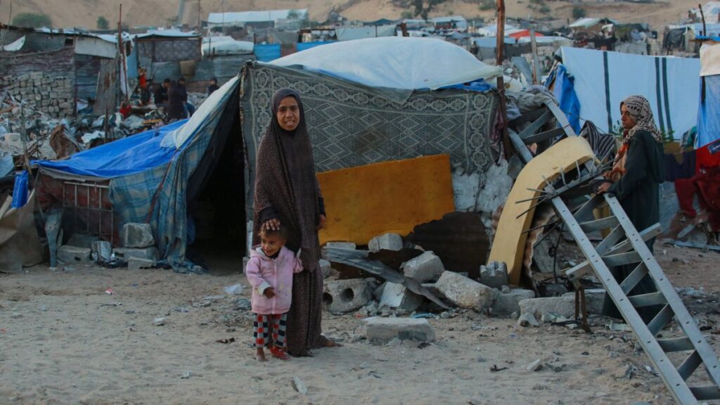People stand outside their shelters at a makeshift camp for displaced Palestinians in the Nahr al-Bared area in Khan Younis, in the southern Gaza Strip, Palestine, Dec. 9, 2024. (AFP Photo)