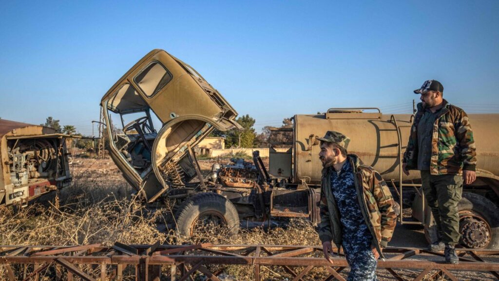 PKK/YPG terrorists inspect damaged and abandoned vehicles at the Qamishli International Airport, formerly a joint Syrian-Russian military base, in the northeastern city of Qamishli, Syria, Dec. 9, 2024. (AFP Photo)