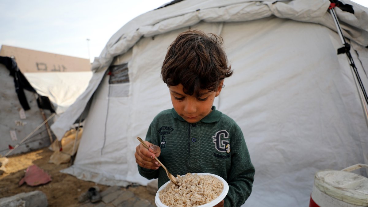 A child eats a meal in a tent camp amid Israeli attacks, Gaza Strip, Palestine, Dec. 17, 2024. (AA Photo)