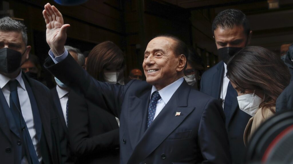 Former Italian Premier Silvio Berlusconi waves to reporters as he arrives at the Chamber of Deputies to meet Mario Draghi, Rome, Italy, Feb. 9, 2021. (AP Photo)