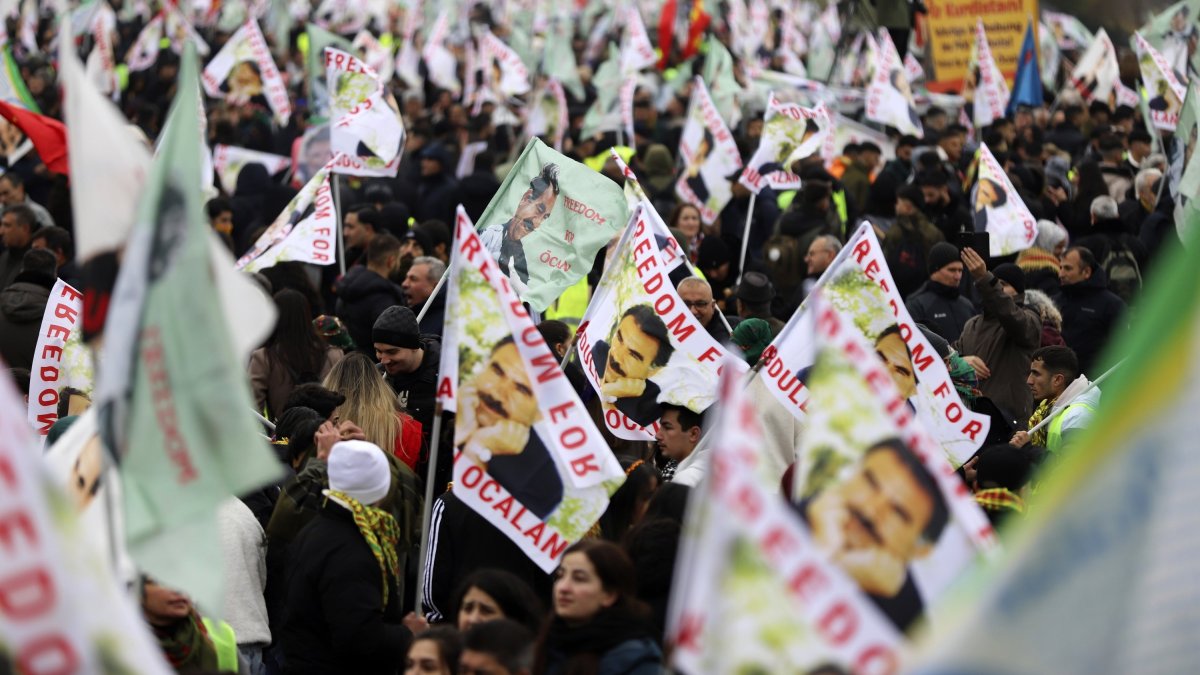 PKK terrorist sympathizers wave posters of the terrorist group's leader, Abdullah Öcalan, during their rally, Cologne, Germany, Nov. 16, 2024. (AP Photo)