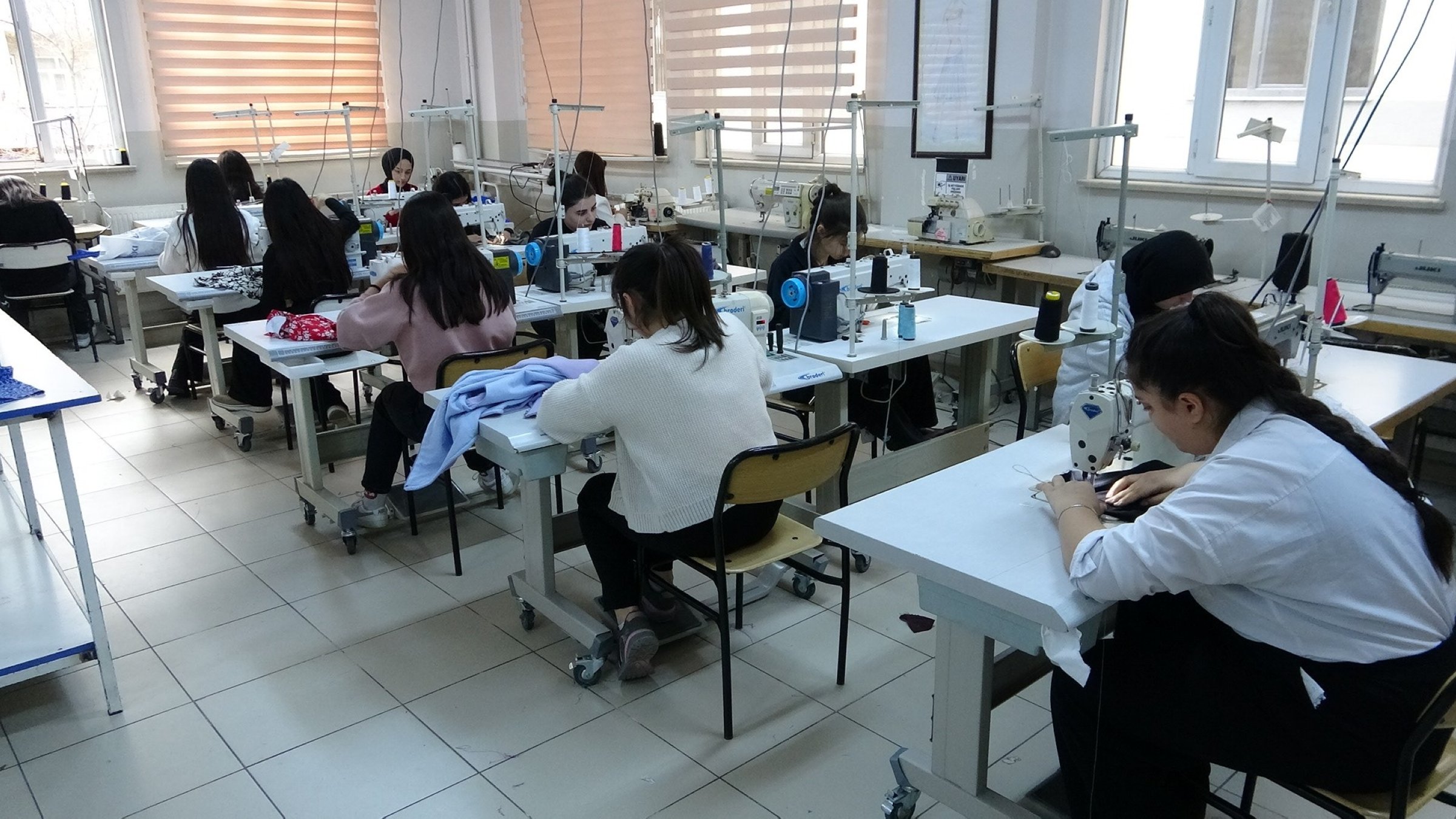 Students in the Fashion Design Department sew clothes for those in need, Van, Türkiye, Dec. 30, 2024. (IHA Photo)