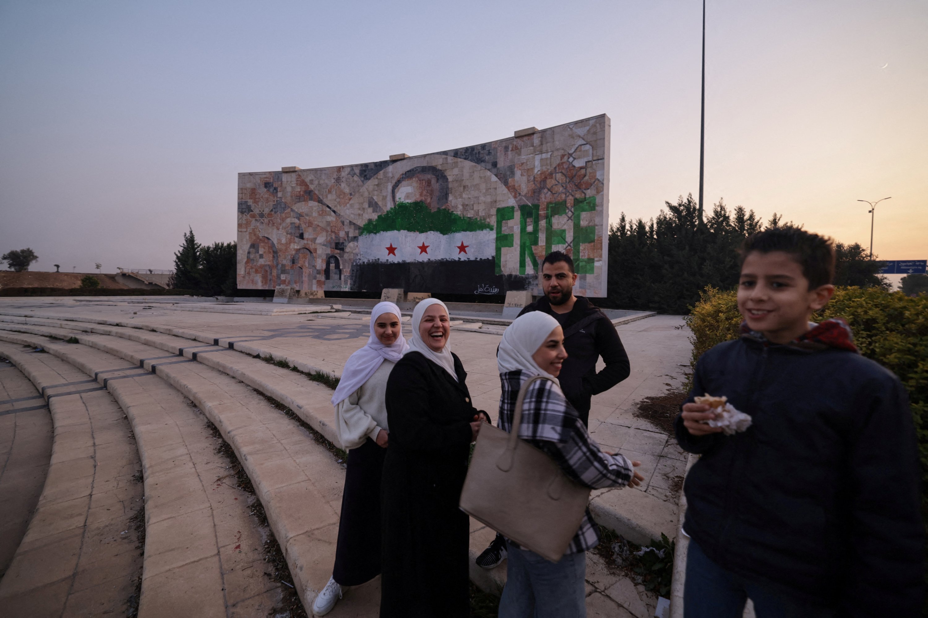 363094 People stand near a graffiti after the ousting of Bashar Assad, in Damascus, Syria, Jan. 2, 2025. (Reuters Photo)