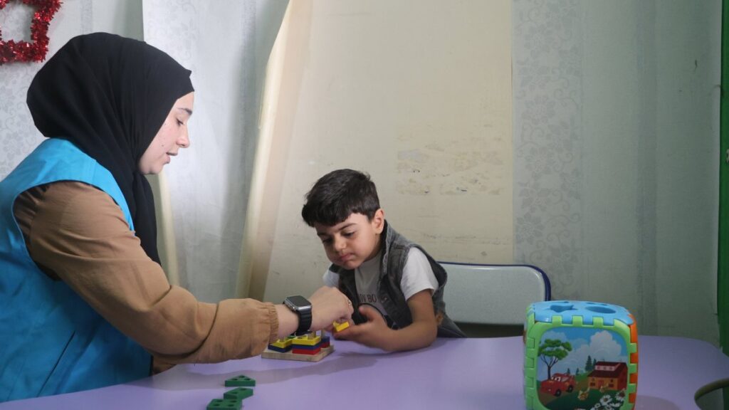 A Türkiye Diyanet Foundation staff member cares for a war-affected child at the foundation's rehabilitation center in Azaz, Syria, Jan. 19, 2025. (AA Photo)