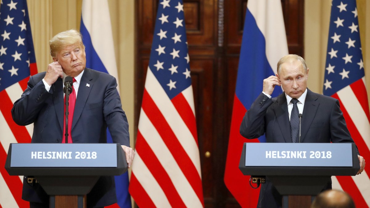 U.S. President Donald J. Trump and Russian President Vladimir Putin adjust their earpiece plugs during a joint news conference following their summit talks at the Presidential Palace in Helsinki, Finland, July 18, 2018. (EPA File Photo)
