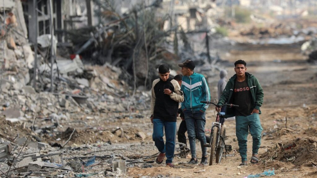 Palestinians walk next to damaged buildings and rubble after Israeli forces withdrew from a part of Nuseirat, central Gaza Strip, Palestine, Nov. 29, 2024. (Reuters Photo)