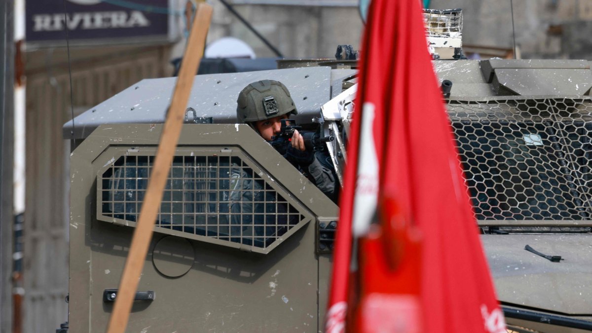An Israeli army soldier aims from an armored vehicle in Tulkarem, occupied West Bank, Palestine, Jan. 28, 2025. (AFP Photo)
