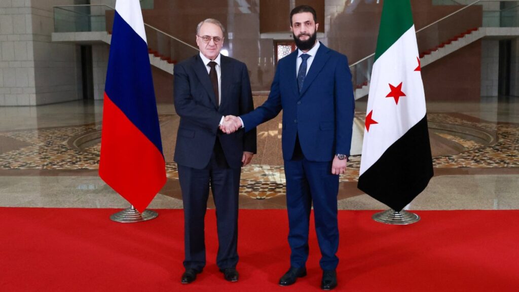 Syria's new leader Ahmed al-Sharaa (R) and Russia's Deputy Foreign Minister Mikhail Bogdanov posing for a picture during their meeting in Damascus, Syria, Jan. 29, 2025. ()