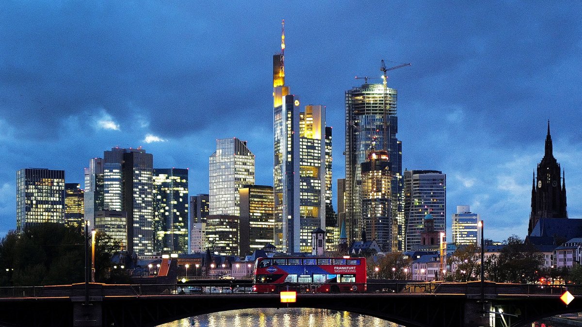 A double-decker bus passes the skyline with its dominating banking district in Frankfurt, Germany, Nov. 8, 2023. (Reuters Photo)