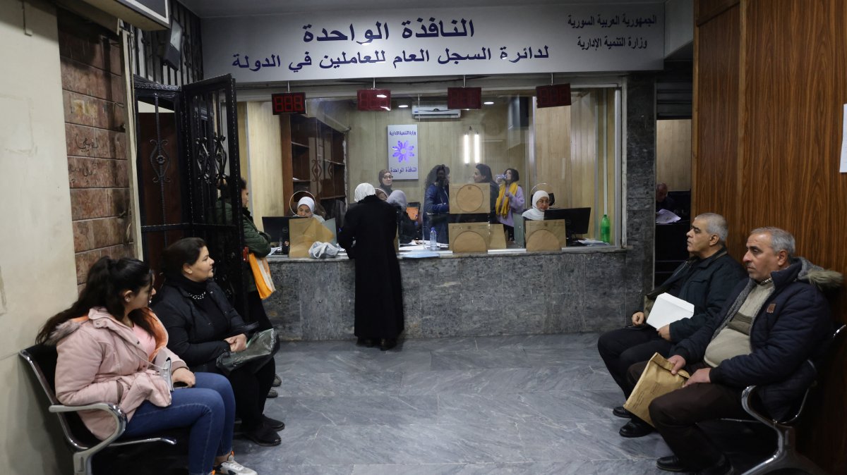 People wait at a government building in Damascus suburb, Syria Jan. 8, 2025. (Reuters Photo)