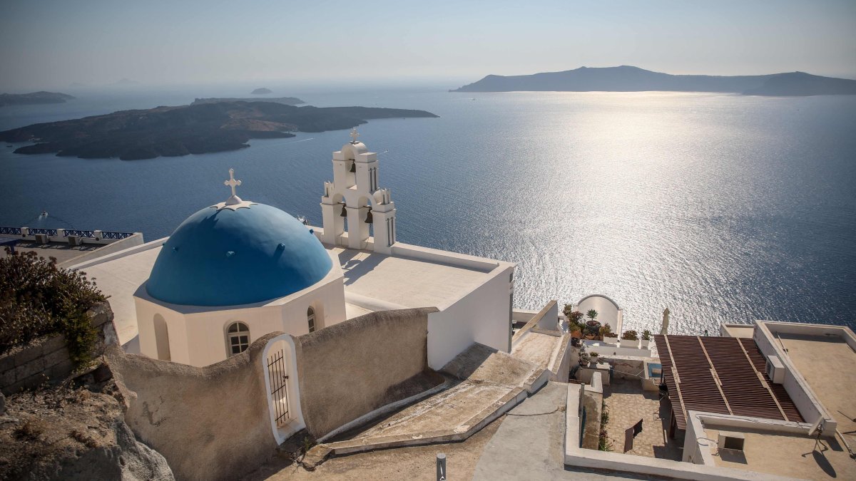 A general view shows the Three Bells of Fira, the Catholic Church of the Dormition, in the village of Fira on the island of Santorini, Greece, July 19, 2024. (AFP Photo)