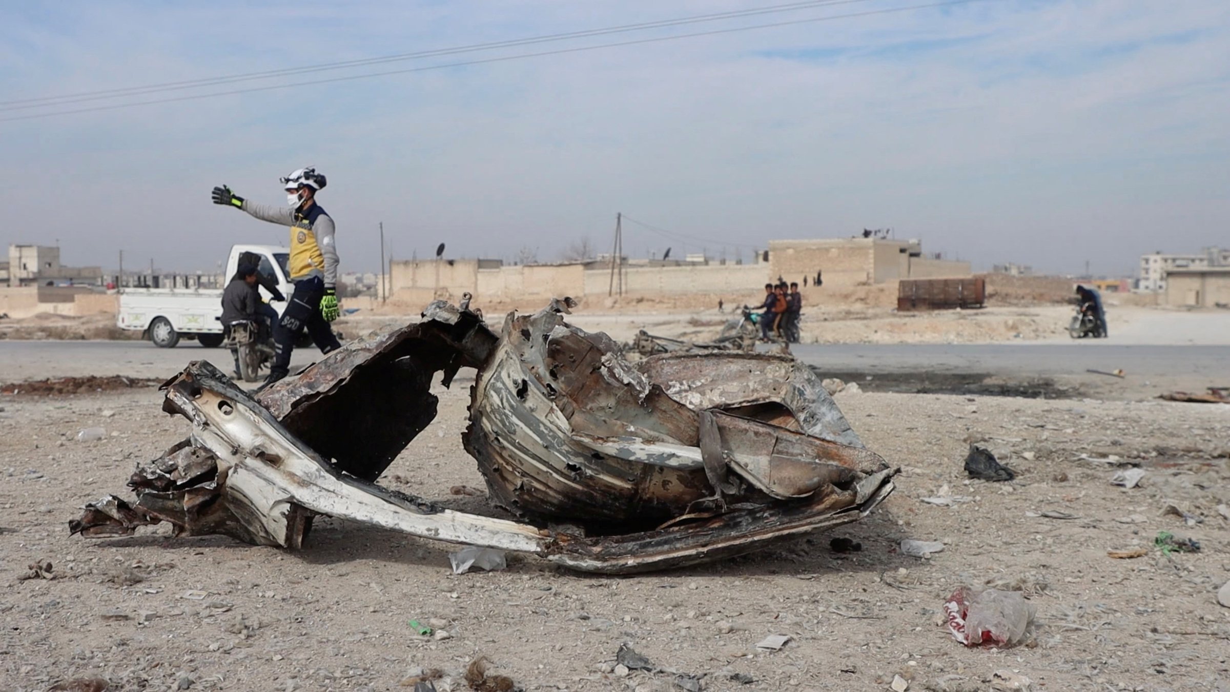 In this screen grab taken from a video, a member of the White Helmets works in the aftermath of a car bomb explosion, Manbij, Syria, Feb. 3, 2025. (Reuters Photo)