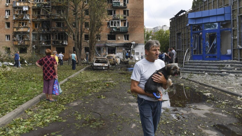 Residents leave an apartment building damaged in shelling by Ukrainian forces in Kursk, Russia, Aug. 11, 2024. (AP Photo)