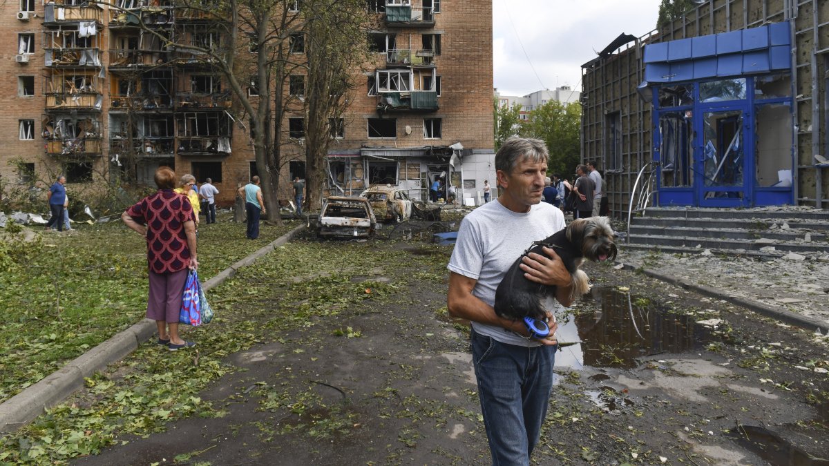 Residents leave an apartment building damaged in shelling by Ukrainian forces in Kursk, Russia, Aug. 11, 2024. (AP Photo)