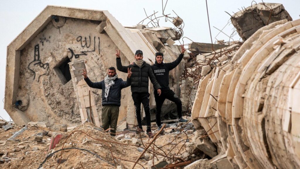 Men gesture as they stand by the remains of a collapsed building in the west of Beit Lahia in the northern Gaza Strip, Palestine, Feb. 11, 2025. (AFP Photo)