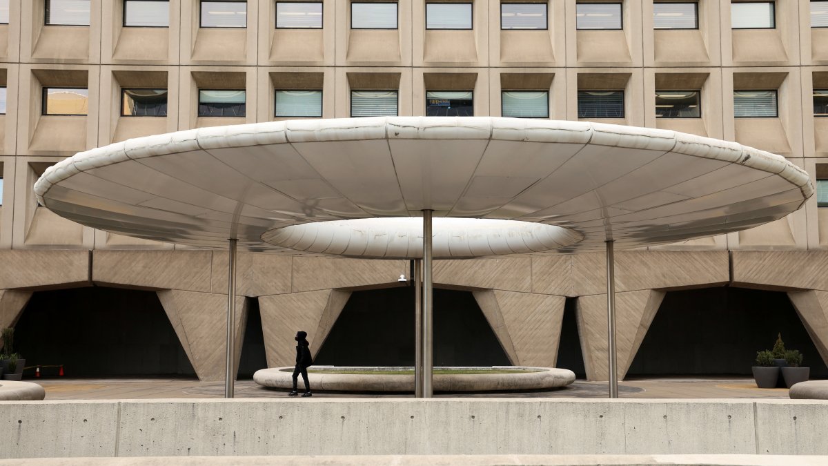 A person walks under a shade canopy in front of the headquarters of the Federal Department of Housing and Urban Development (HUD), days after U.S. President Donald Trump offered buyouts to thin the ranks of civil-service workers, Washington, U.S., Feb. 3, 2025. (Reuters Photo)