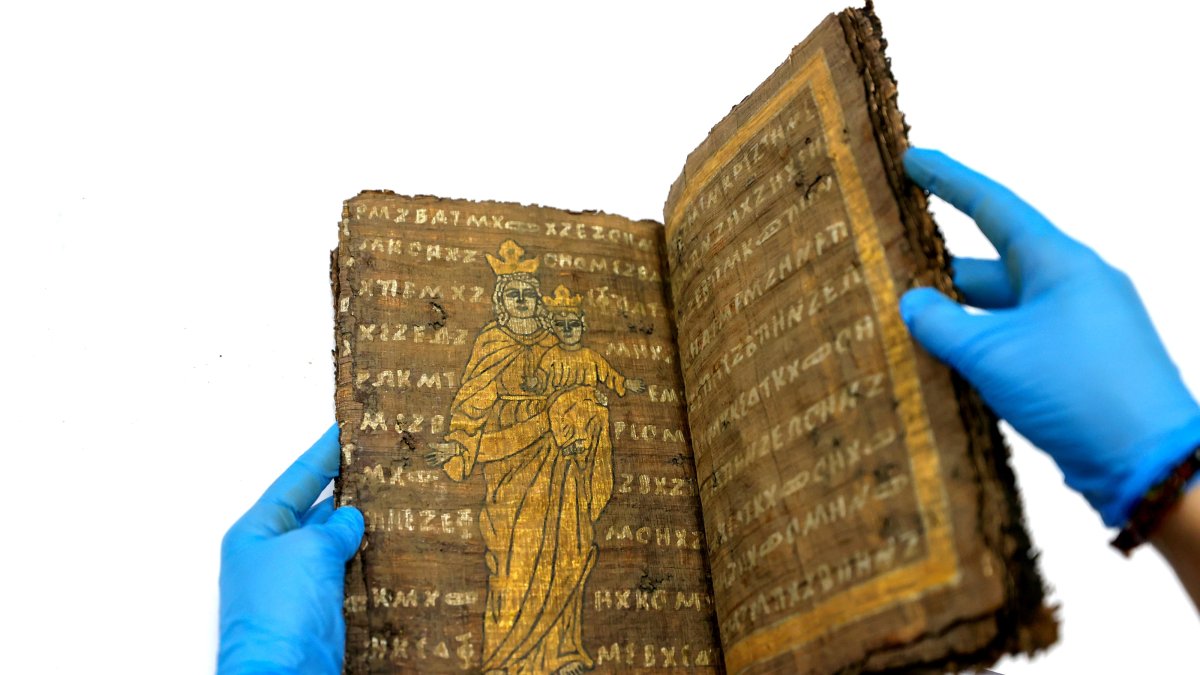 A historical manuscript is examined as part of efforts to identify counterfeit religious artifacts in Konya, Türkiye, Feb. 12, 2025. (AA Photo)