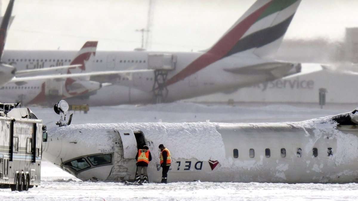 A Delta Air Lines plane lies upside down at Toronto Pearson Airport, Canada, Feb. 18, 2025. (AP Photo)