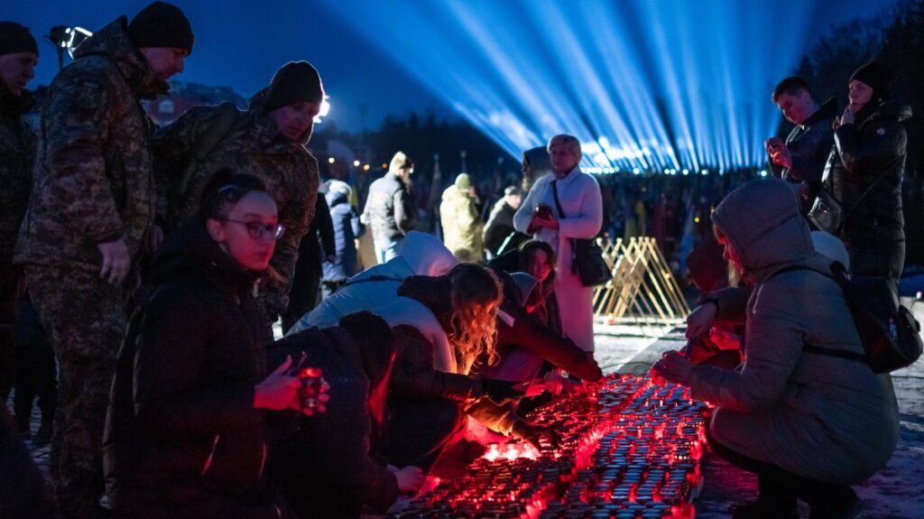 Citizens and families of Ukrainian soldiers, who were killed during the Russia-Ukraine war, take part in a ceremony to honor the memory of fallen soldiers on the eve of the third anniversary of the Russian-Ukrainian war, where "rays of remembrance" are lit into the sky above the Lychakiv Cemetery, Lviv, Ukraine, Feb. 23, 2025. (AA Photo)