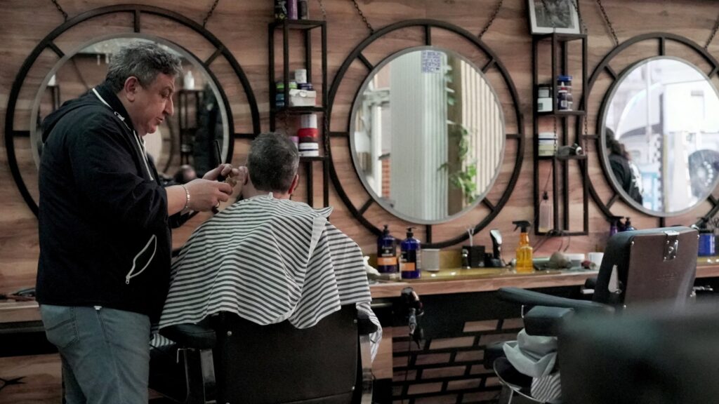 Syrian German Barber Mohammad Azmouz works at a barber shop in the Neukoelln neighborhood, Berlin, Germany, Feb. 24, 2025. (Reuters Photo)