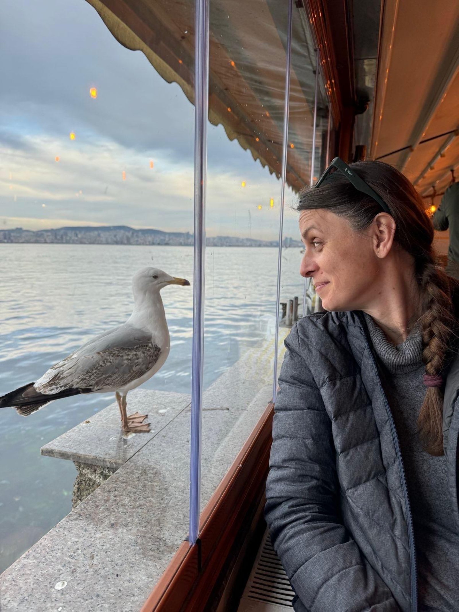 370679 Sarah Howard watches a seagull from a boat near Büyükada Island, Istanbul, Türkiye, April 2025. (Courtesy of Sarah Howard)