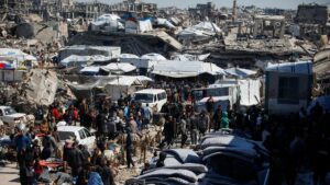 Palestinians gather to receive aid provided by UNRWA including food supplies, after Israel says it has ceased entry of humanitarian aid into Gaza, outside a distribution center, at Jabalia refugee camp in northern Gaza Strip, March 2, 2025. (Reuters Photo)