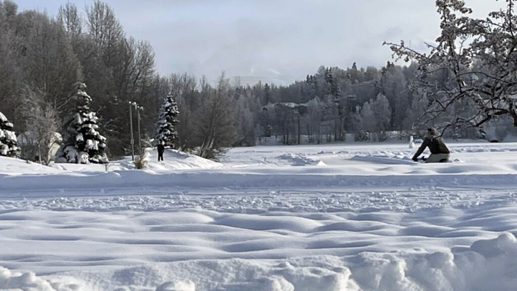 A man rides a fat tire bike on a plowed sidewalk through Westchester Lagoon in Anchorage, Alaska, Thursday, Feb. 1, 2024. (AP File Photo)