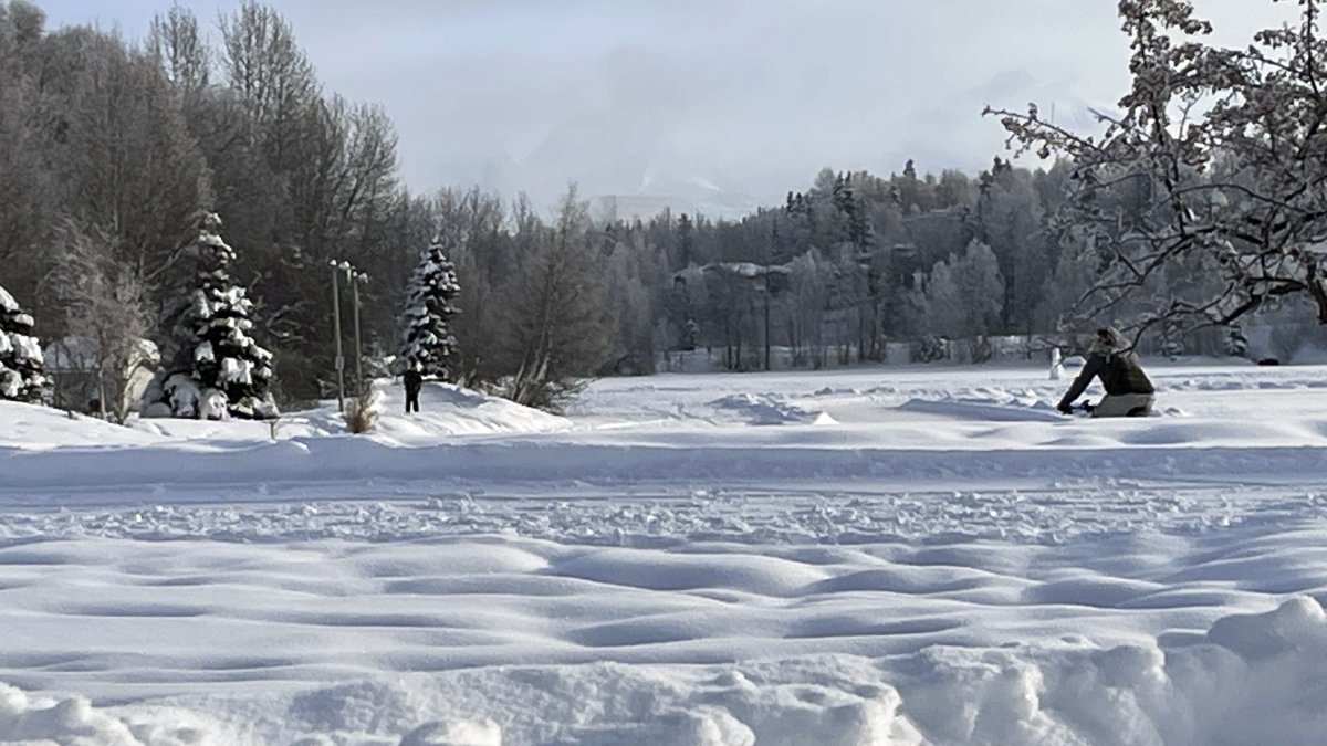 A man rides a fat tire bike on a plowed sidewalk through Westchester Lagoon in Anchorage, Alaska, Thursday, Feb. 1, 2024. (AP File Photo)
