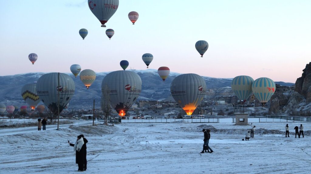 Tourists are seen below hot air balloons, Cappadocia, central Türkiye, Feb. 23, 2025. (AA Photo)