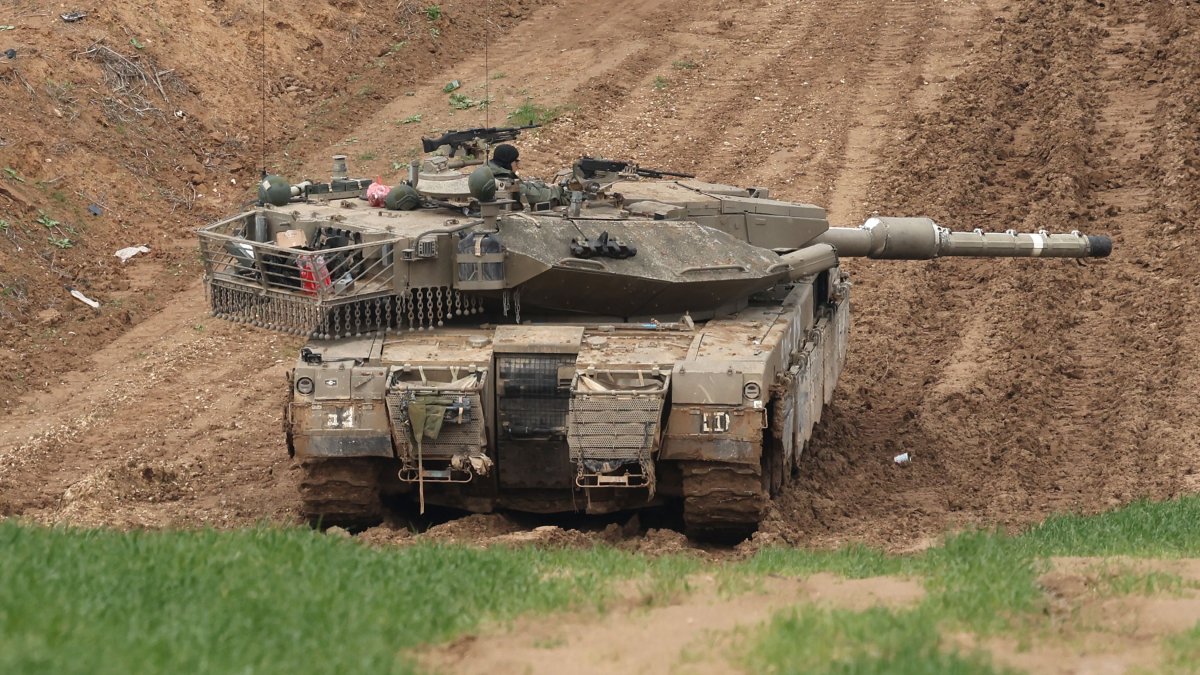 This picture taken from the Israeli side of the border with the Gaza Strip shows an Israeli army tank stationed on a hill overlooking northern Gaza, Feb. 12, 2025. (AFP File Photo)