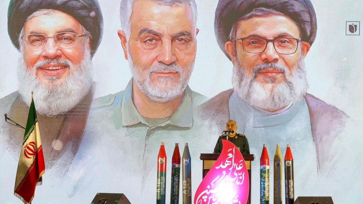 Iran's Revolutionary Guard Corps Commander-in-Chief Major General Hossein Salami speaks during a memorial service beneath portraits of slain Hezbollah leader Hassan Nasrallah (L), Iranian Gen. Qassem Soleimani (C) and Nasrallah's successor Hashem Safieddine at Tehran's Grand Mosque, Tehran, Iran, Feb. 23, 2025. (AFP Photo)