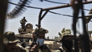 U.S.-backed PKK/YPG-led SDF fighters sit on their armored vehicles, at al-Sabha town in the eastern countryside of Deir el-Zour, Syria, Monday, Sept. 4, 2023. (AP File Photo)