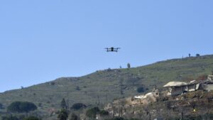 An Israeli drone flies during a mass funeral of Hezbollah fighters who died during fights with the Israeli army before the cease-fire, in Kfar Kila village, southern Lebanon, March 9, 2025. (EPA Photo)