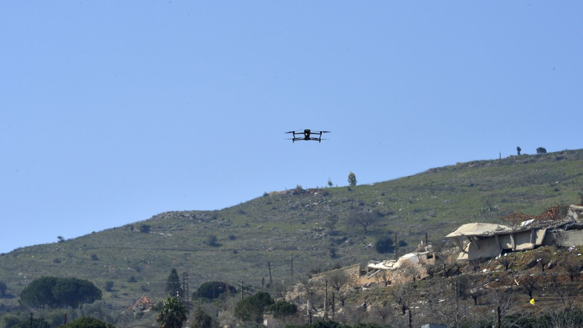 An Israeli drone flies during a mass funeral of Hezbollah fighters who died during fights with the Israeli army before the cease-fire, in Kfar Kila village, southern Lebanon, March 9, 2025. (EPA Photo)