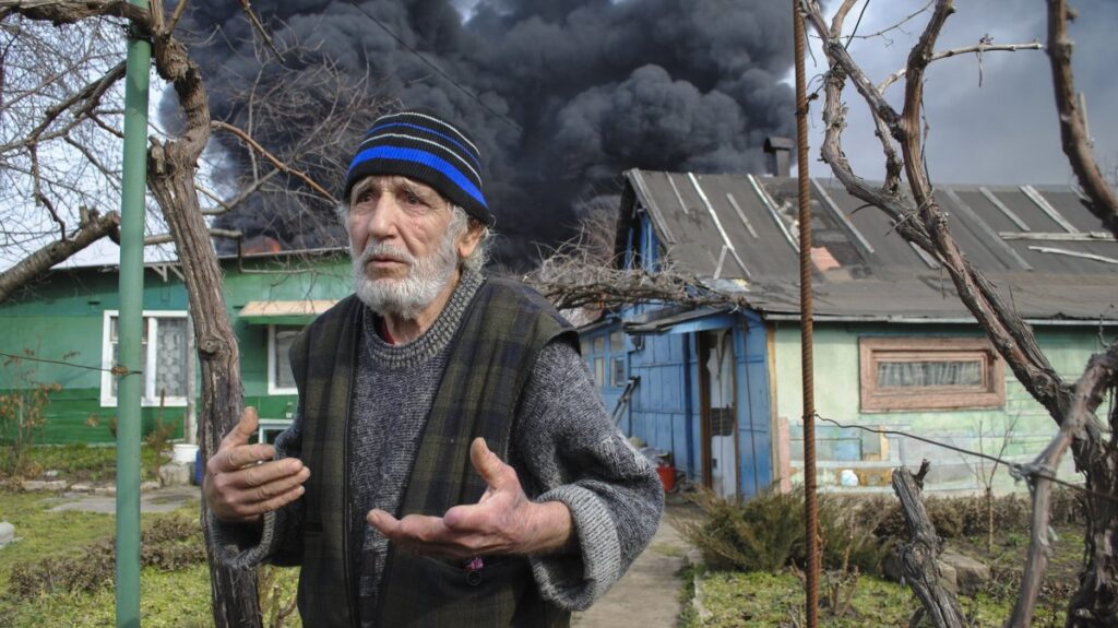 A man reacts as smoke billows above the site of a drone attack, Odesa, Ukraine, March 11, 2025. (EPA Photo)