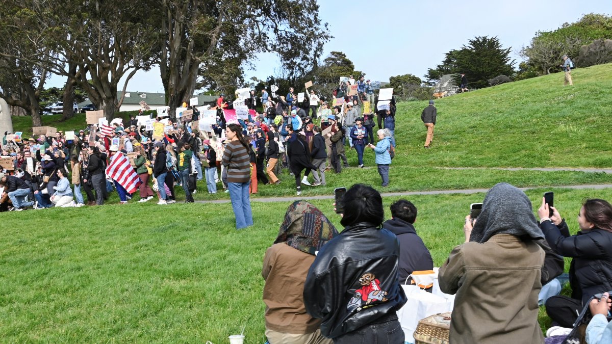San Francisco residents having a picnic, photograph a group of protesters during a demonstration as part of a nationwide series of protests planned at federal park sites, against the mass firings of National Park Service employees in a campaign by President Donald Trump and his adviser Elon Musk to radically cut back the U.S. bureaucracy, at Fort Mason Park in San Francisco, California, U.S. March 1, 2025. (Reuters Photo)