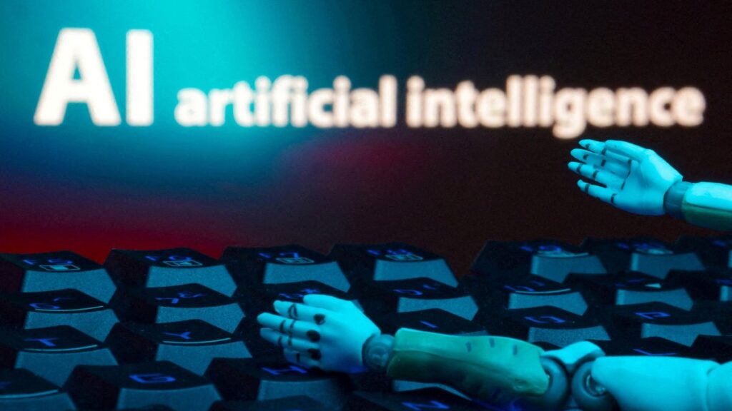 A message reading "AI artificial intelligence," a keyboard and robot hands are seen in this illustration taken Jan. 27, 2025. (Reuters Photo)