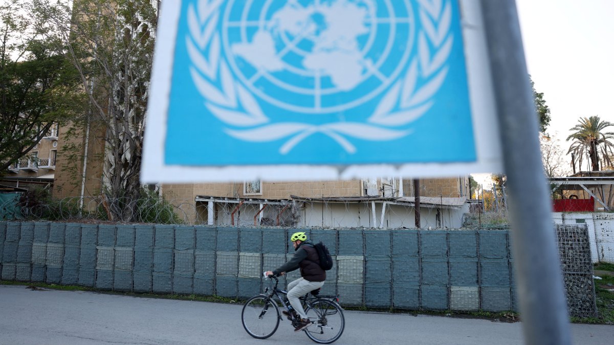 A man crosses the Ledra Palace checkpoint on his bicycle in the U.N. buffer zone, Nicosia, Cyprus, Dec. 5, 2024. (Reuters Photo)