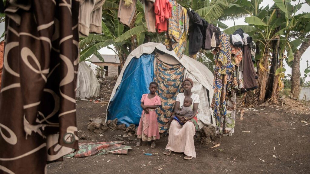 A displaced woman, who is among those who have returned to their homes only to find that they were destroyed, poses for a photo with her children, Sake, DRC, Feb. 27, 2025. (AFP Photo)