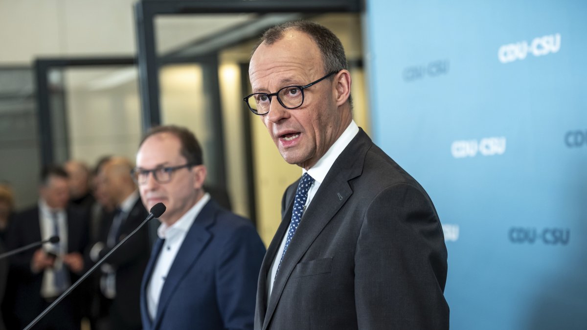 Friedrich Merz (R) CDU/CSU parliamentary group leader in the Bundestag and CDU federal chair, makes a statement after the parliamentary group meeting in the Bundestag, Berlin, Germany, March 14, 2025. (AP Photo)