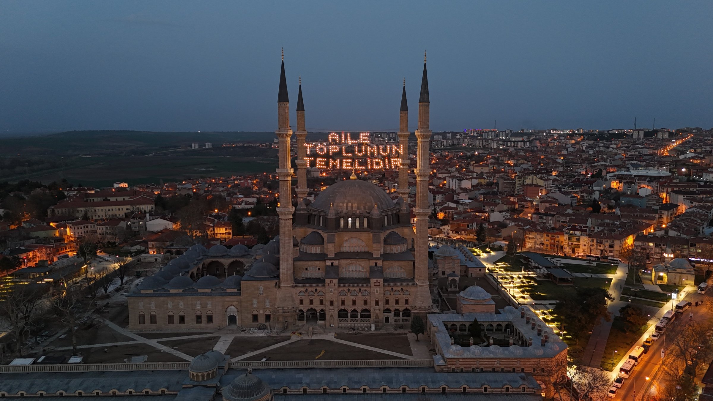 The illuminated mahya reading "Family is the foundation of society" hangs the minarets of Selimiye Mosque, Edirne, Türkiye, March 17, 2025. (IHA Photo)