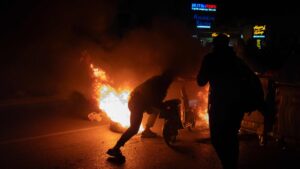 Protesters push a scooter into a barricade fire during a demonstration following the arrest of Istanbul's mayor, in Izmir, Türkiye, March 21, 2025. (AFP photo)