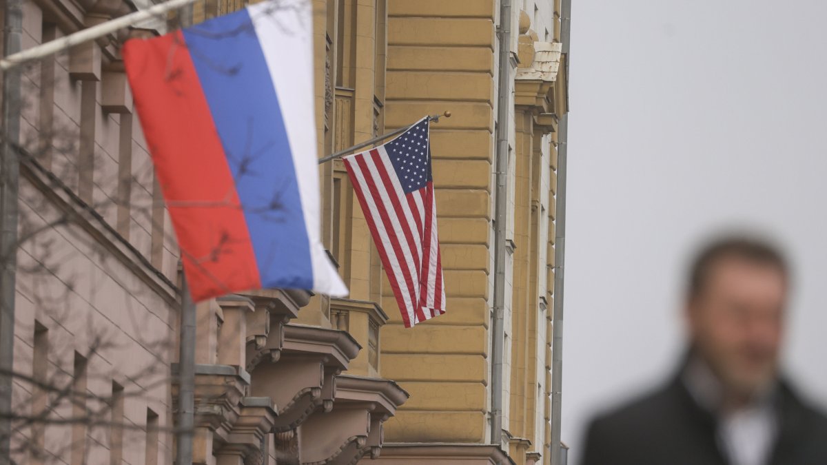 A man walks near Russian and U.S. flags hanging on the main building of the U.S. Embassy in Moscow, Russia, March 12, 2025. (EPA Photo)
