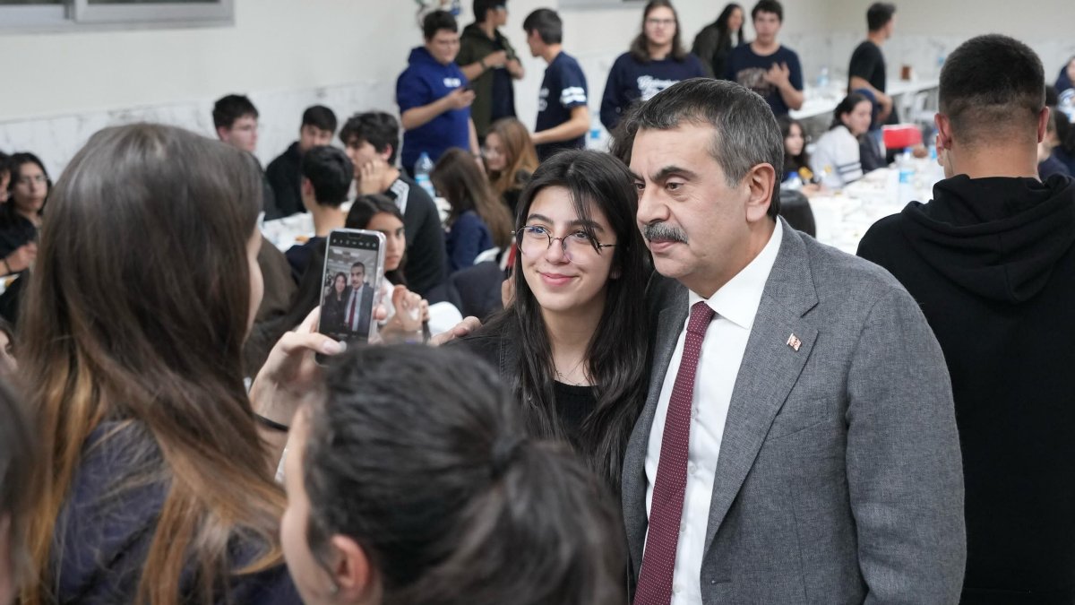 Education Minister Yusuf Tekin poses with a student during an iftar program at a high schoolö Ankara, Türkiye, March 20, 2025. (AA Photo)