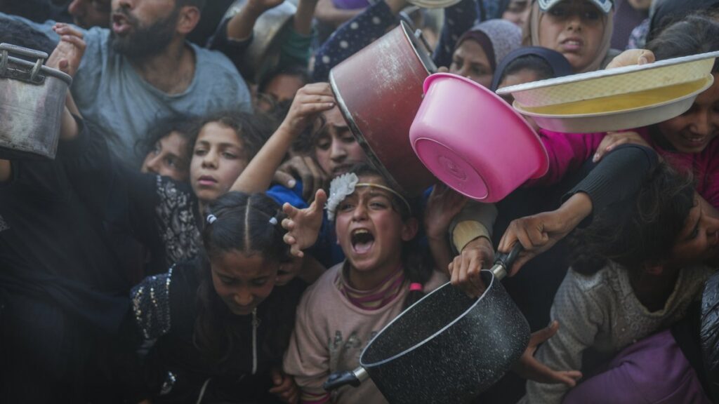Palestinian children struggle while waiting for donated food at a distribution center, Beit Lahiya, Gaza Strip, Palestine, March 16, 2025. (AP Photo)