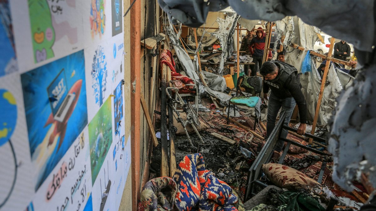 A Palestinian journalist inspects the damage from an Israeli attack that killed one of his colleagues in Khan Younis, southern Gaza, Palestine, April 7, 2025. (AA Photo)