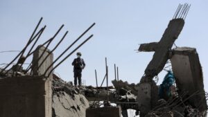 In this file photo, a man inspects a damaged building after a U.S. airstrike in Sana'a, Yemen, April 7, 2025. (EPA Photo)